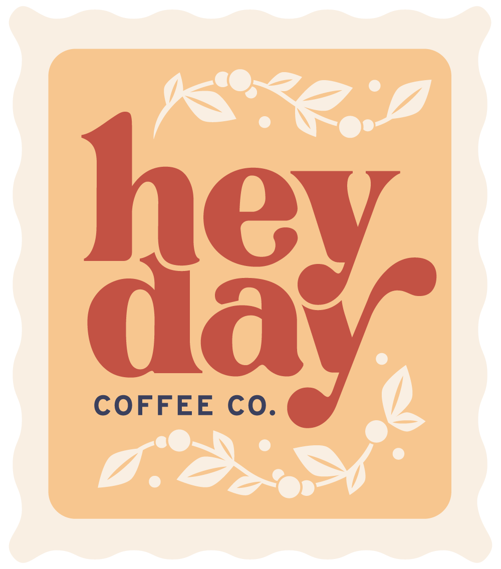 stylized stamp of the Heyday logo surrounded by leaves.